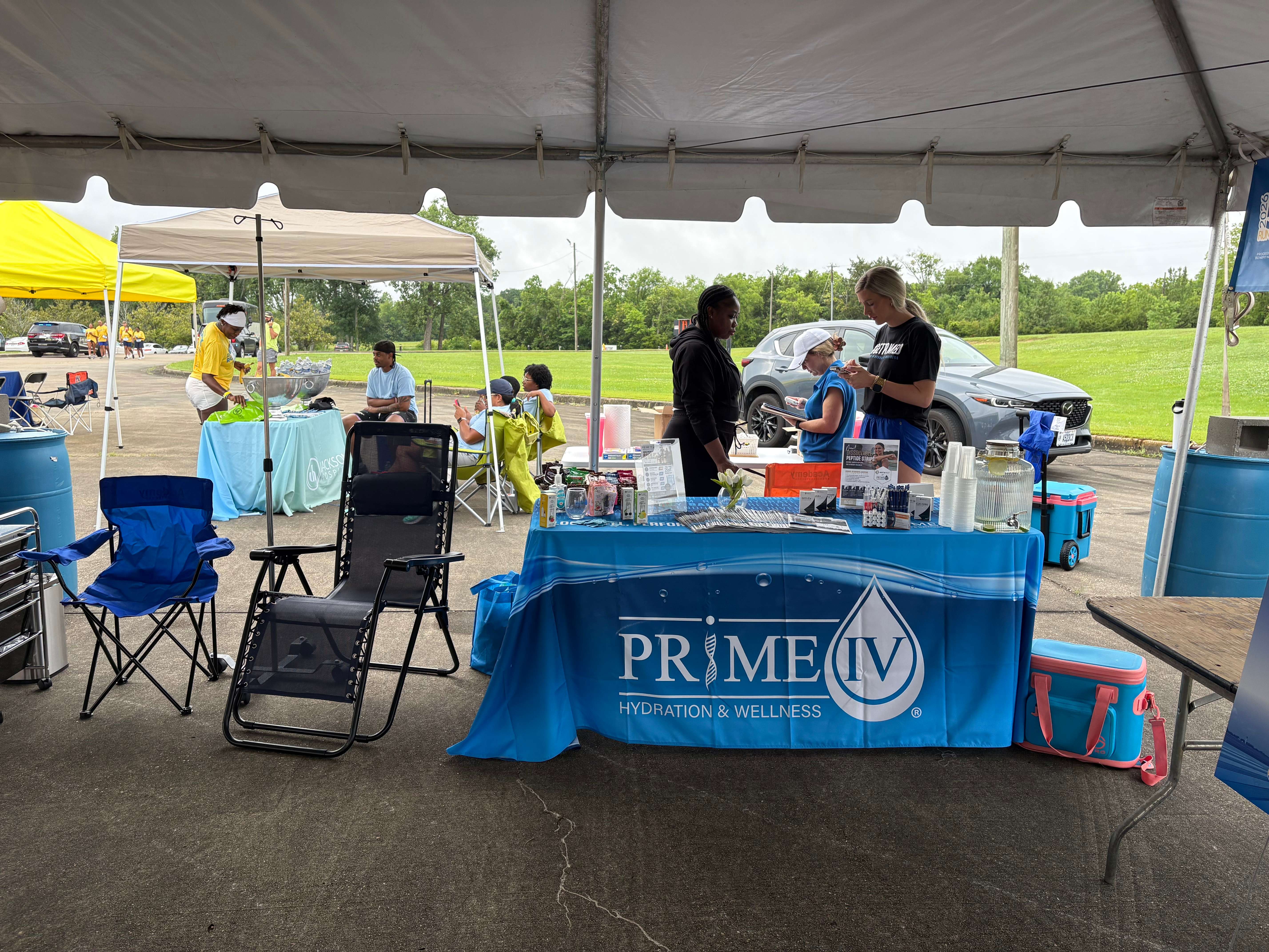 The Prime IV Montgomery team at a local community run event with a branded booth